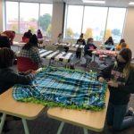 Students creating no sew blankets