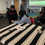 Students creating a blanket